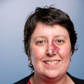 Head shot of a smiling, dark-haired European woman Joanna Raven