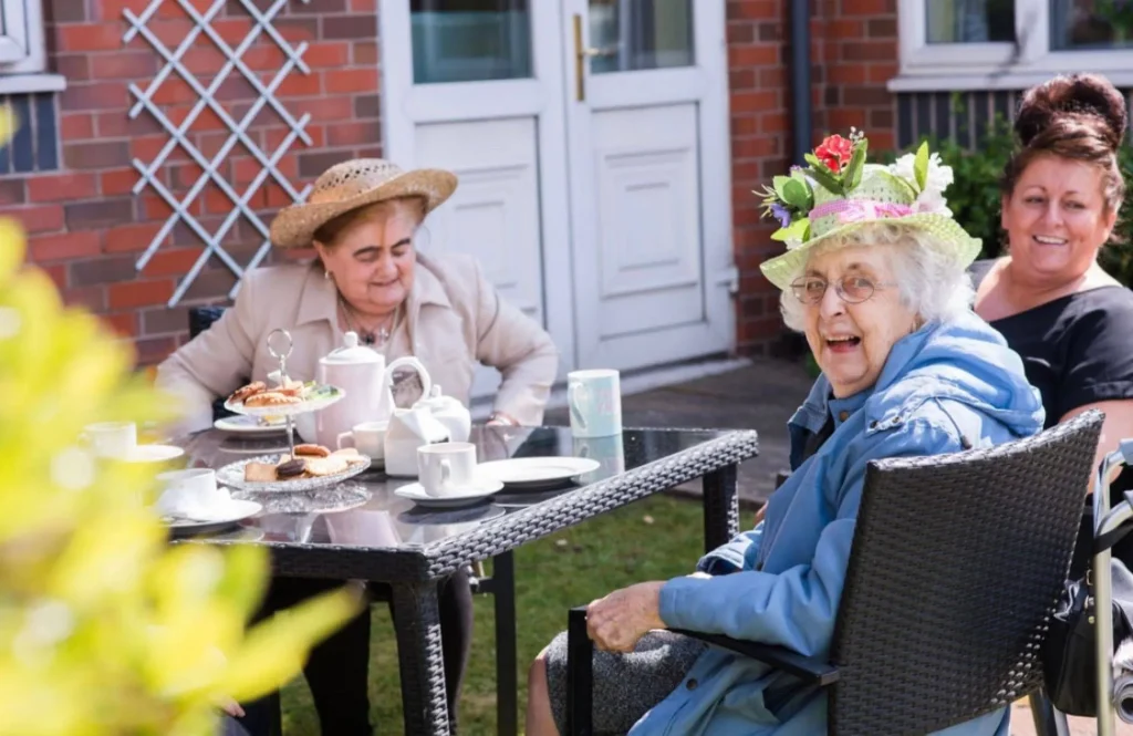 Happy Service users having afternoon tea